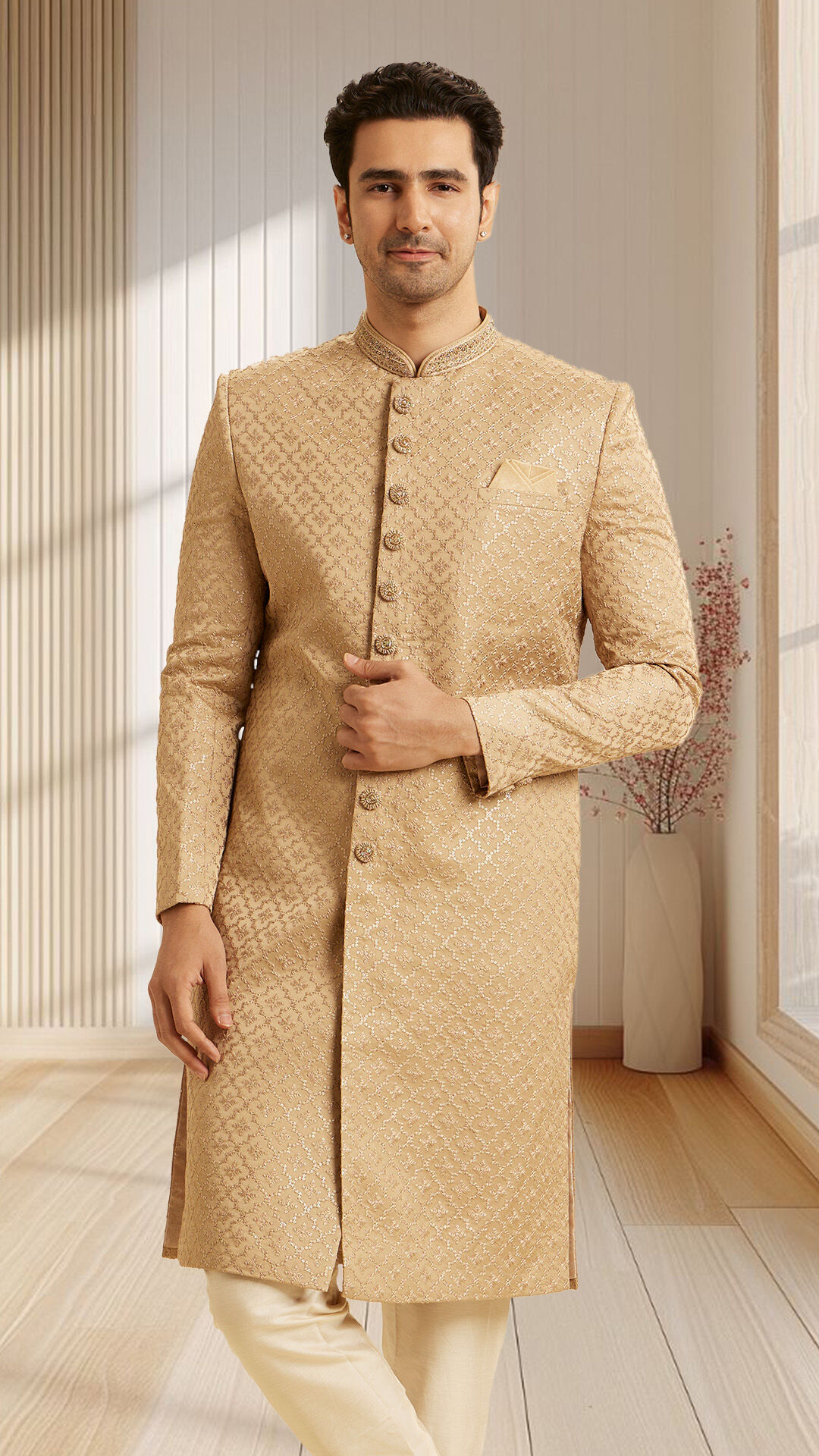 Groom wearing golden embroidered sherwani with a classic fit, posing indoors for wedding style inspiration
